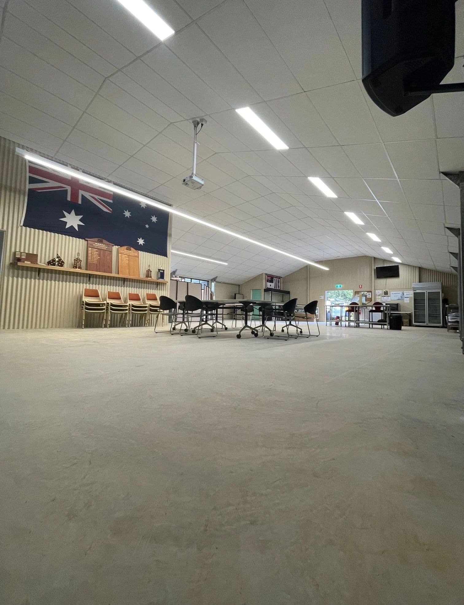 Suspended ceiling with acoustic tiles and linear lighting in a community hall